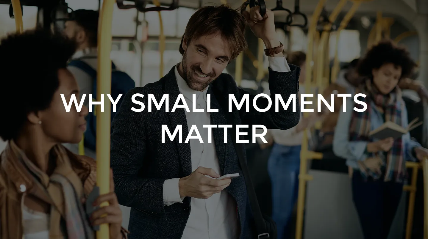 A smiling man chatting with a woman on a city bus
