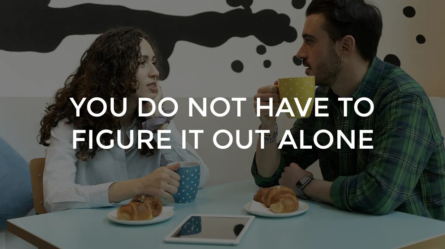 Two friends talking over coffee and croissants