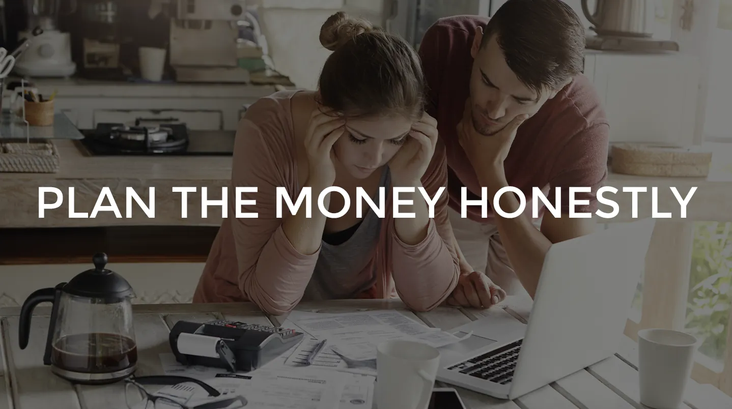 A couple reviewing bills together at the kitchen table