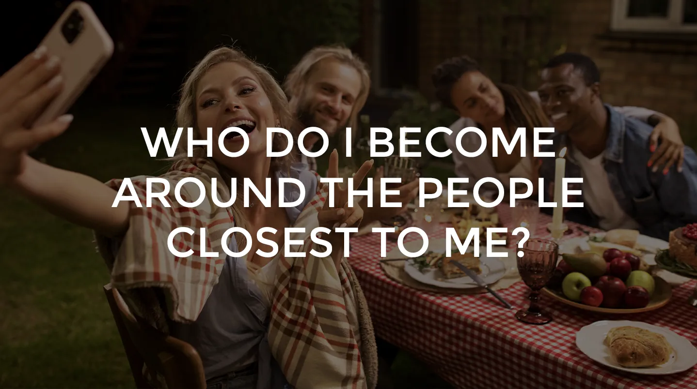 Friends taking a selfie around an outdoor dinner table