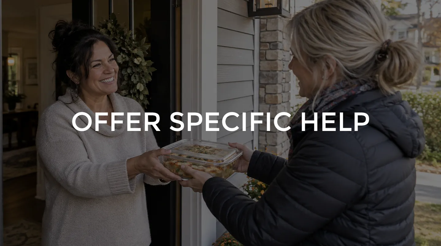 A woman handing a home-cooked dish to a neighbor at the door
